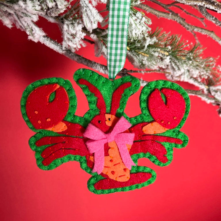 Handcrafted Lobster Felt Christmas Ornament on a red background