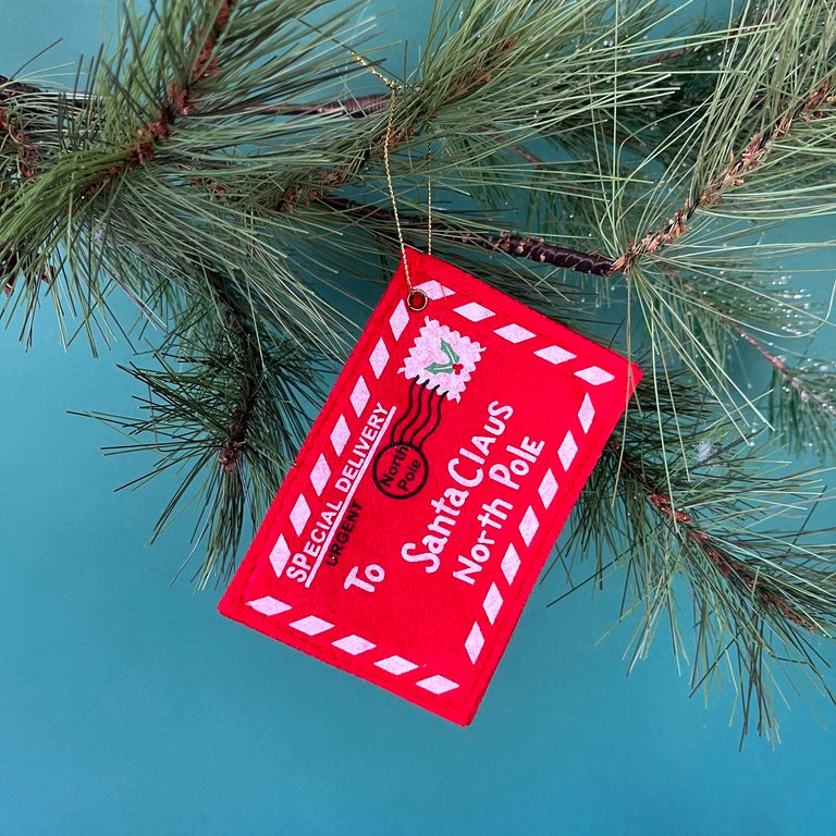 Felt letter to santa christmas ornament on a green background