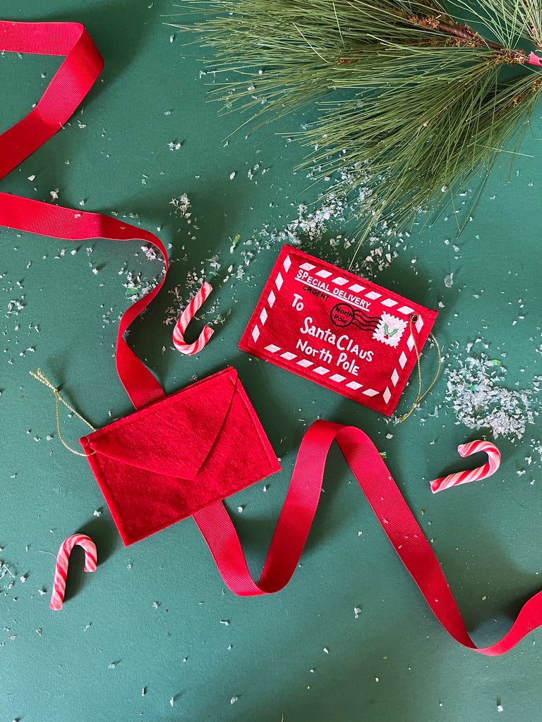 Felt letter to santa christmas ornament on a green background