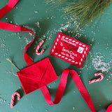 Felt letter to santa christmas ornament on a green background