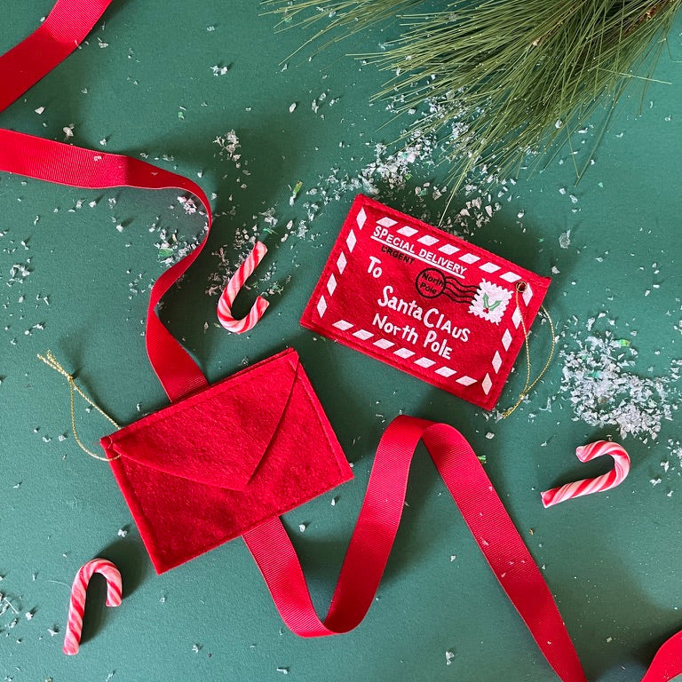 Felt letter to santa christmas ornament on a green background