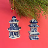 Two blue and white pagoda ginger jar chinoiserie ornaments hanging from a Christmas tree.
