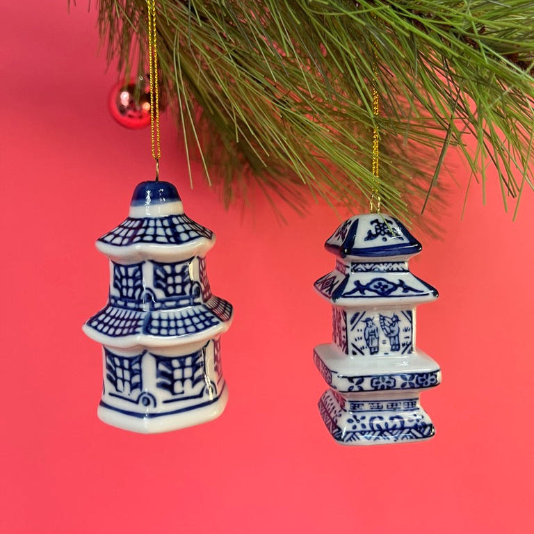 Two blue and white pagoda ginger jar chinoiserie ornaments hanging from a Christmas tree.
