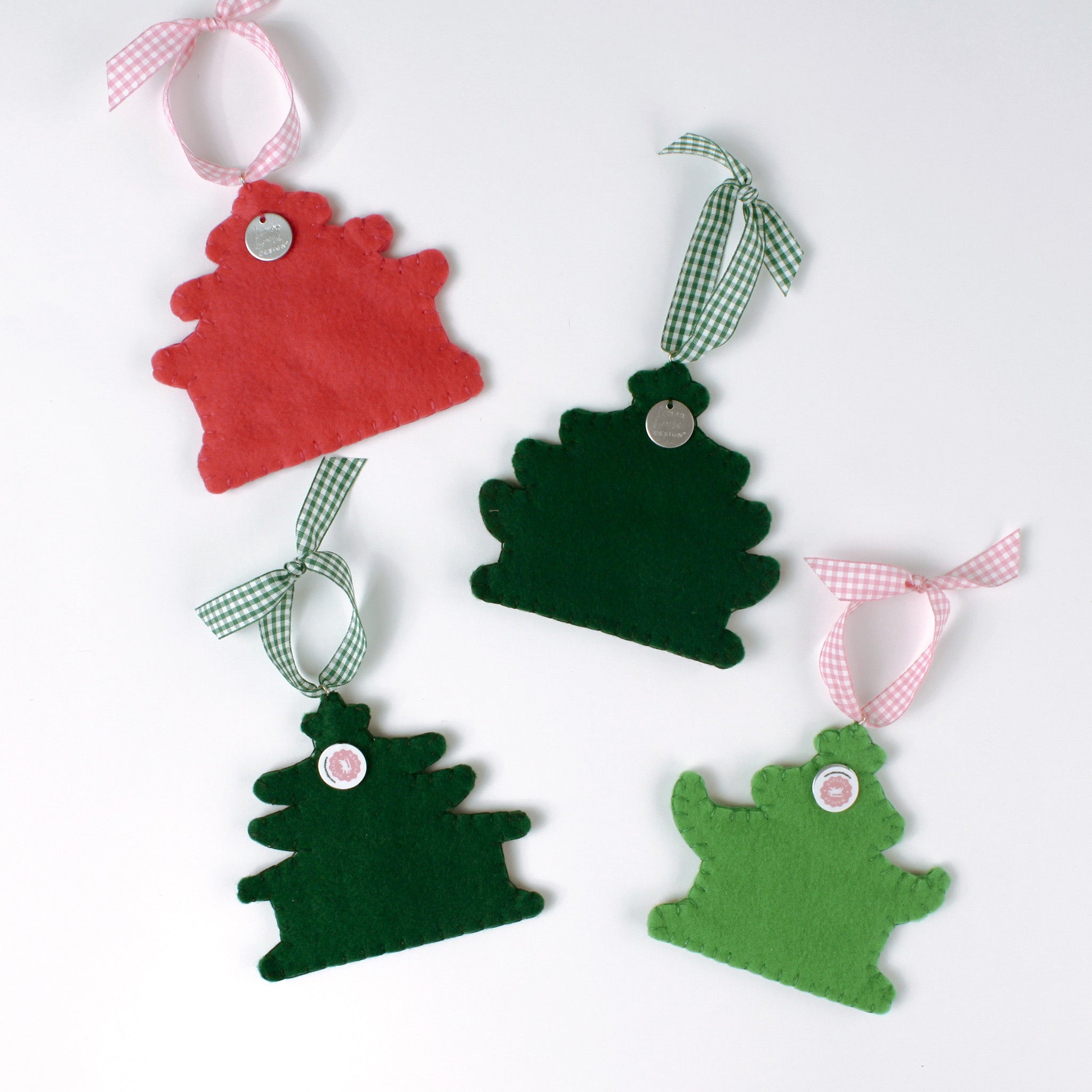 back of a four pink felt chinoiserie christmas ornaments in the shape of pagodas against a white background 