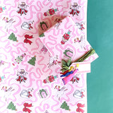 Gift wrapped in pink nutcracker Christmas paper with green velvet ribbon and matching gift tag.