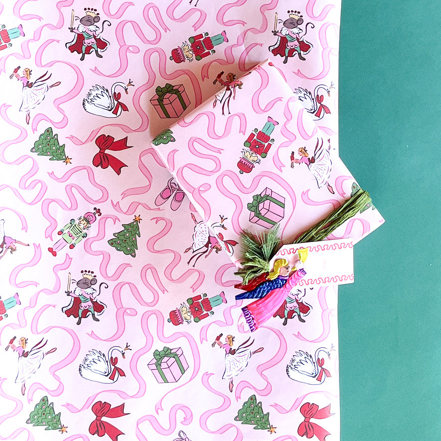 Gift wrapped in pink nutcracker Christmas paper with green velvet ribbon and matching gift tag.
