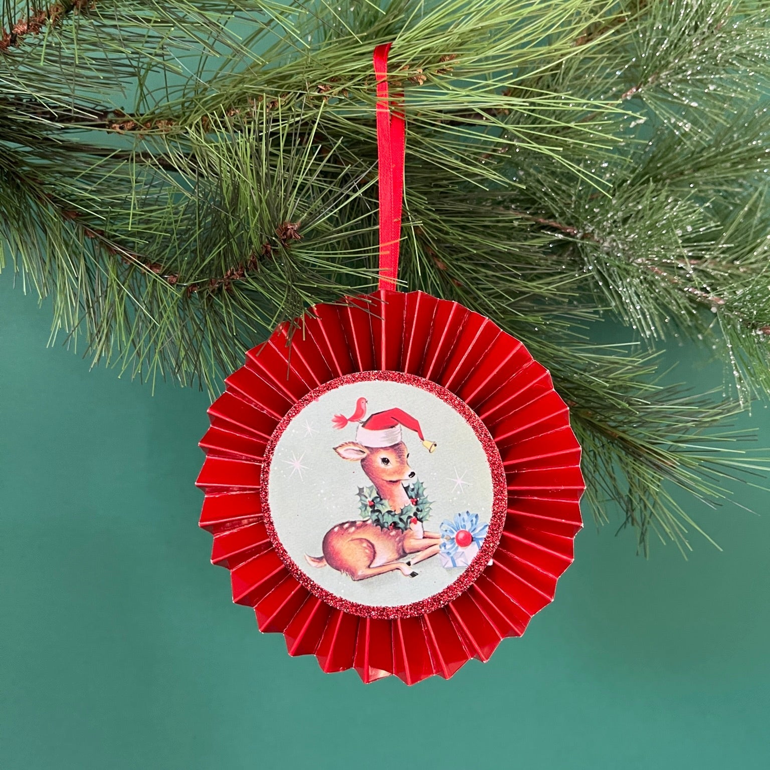 retro-style ruffled paper Christmas ornaments featuring vintage illustration, accented with red pleated borders and hanging ribbons