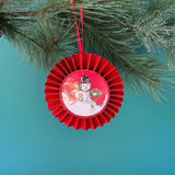 retro-style ruffled paper Christmas ornaments featuring vintage illustration, accented with red pleated borders and hanging ribbons