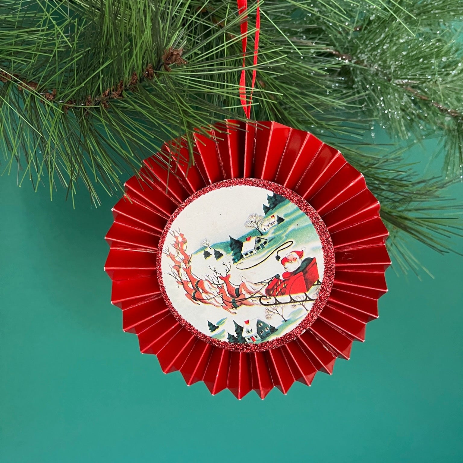 retro-style ruffled paper Christmas ornaments featuring vintage illustration, accented with red pleated borders and hanging ribbons