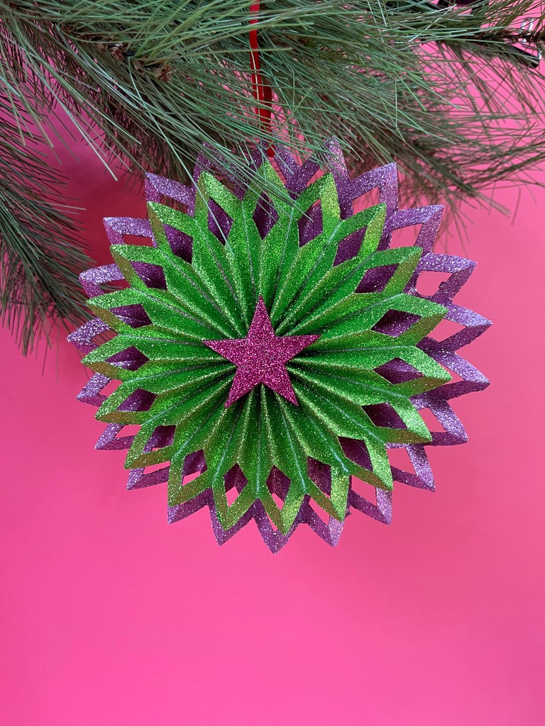 ruffled paper Christmas ornaments in shimmering green and purple glitter with red centers