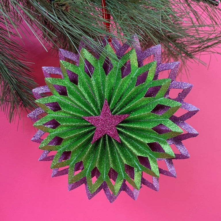 ruffled paper Christmas ornaments in shimmering green and purple glitter with red centers