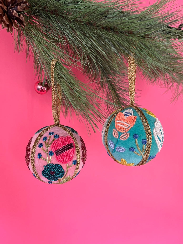 Set of two velvet Christmas ball ornaments in soft pink and mint green, beautifully hand-embroidered with beaded floral designs and finished with gold braided trim and hanging loops