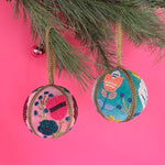 Set of two velvet Christmas ball ornaments in soft pink and mint green, beautifully hand-embroidered with beaded floral designs and finished with gold braided trim and hanging loops