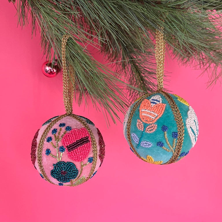 Set of two velvet Christmas ball ornaments in soft pink and mint green, beautifully hand-embroidered with beaded floral designs and finished with gold braided trim and hanging loops