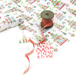 Holiday pagoda print wrapping paper styled with red ribbon spool and gift tags.