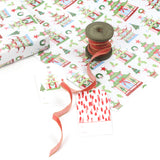 Holiday pagoda print wrapping paper styled with red ribbon spool and gift tags.