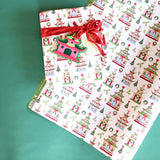 Gift wrapped in pagoda Christmas print paper with red ribbon and matching holiday tag.