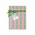 A blue gift tag with a geometric pattern, attached to a wrapped present