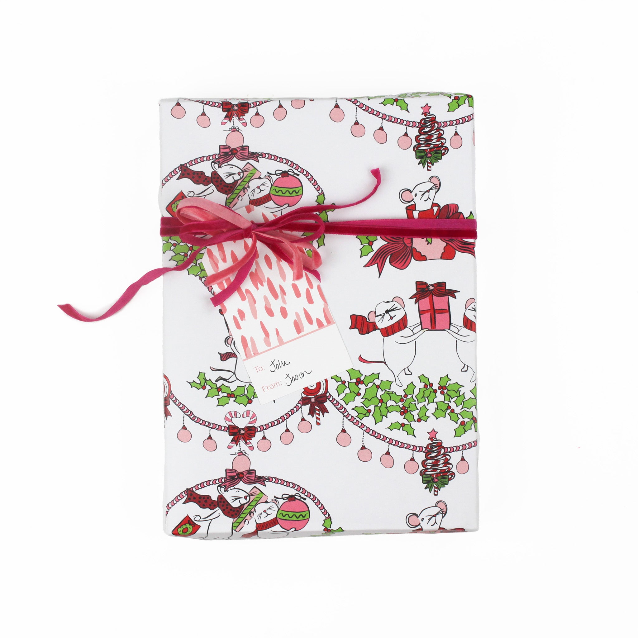 A pink gift tag with a geometric pattern, attached to a wrapped present