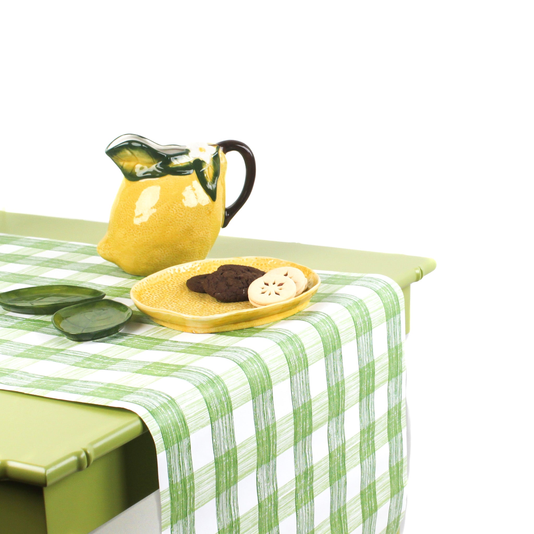 a green table covered by a Gin Lane Green Gingham Paper Table Runner on a white background