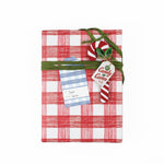 A blue gingham patterned gift tag with a white space for personalization, added to a wrapped present