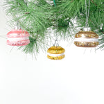macaron ornaments hanging on a chrismtas tree