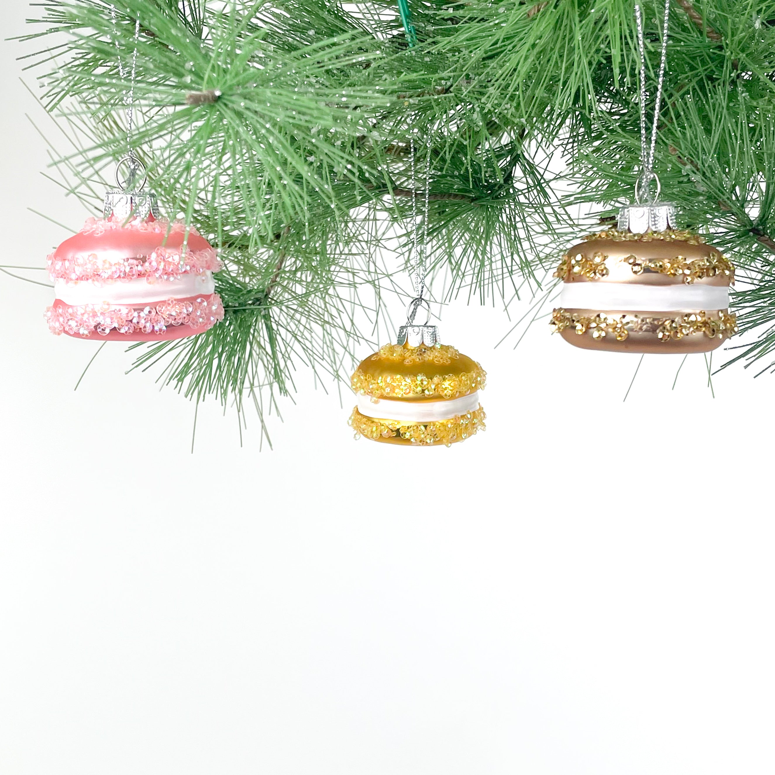 macaron ornaments hanging on a chrismtas tree
