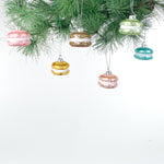 macaron ornaments hanging on a chrismtas tree