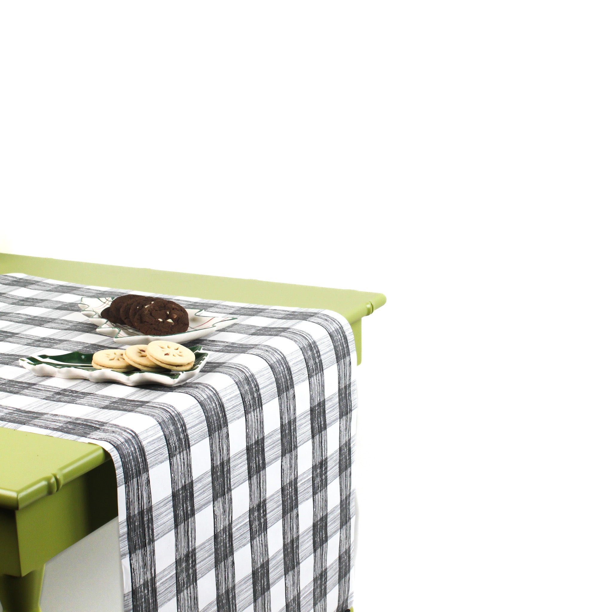 a green table covered with a black paper table runner in a black and white gingham pattern from madcap cottage