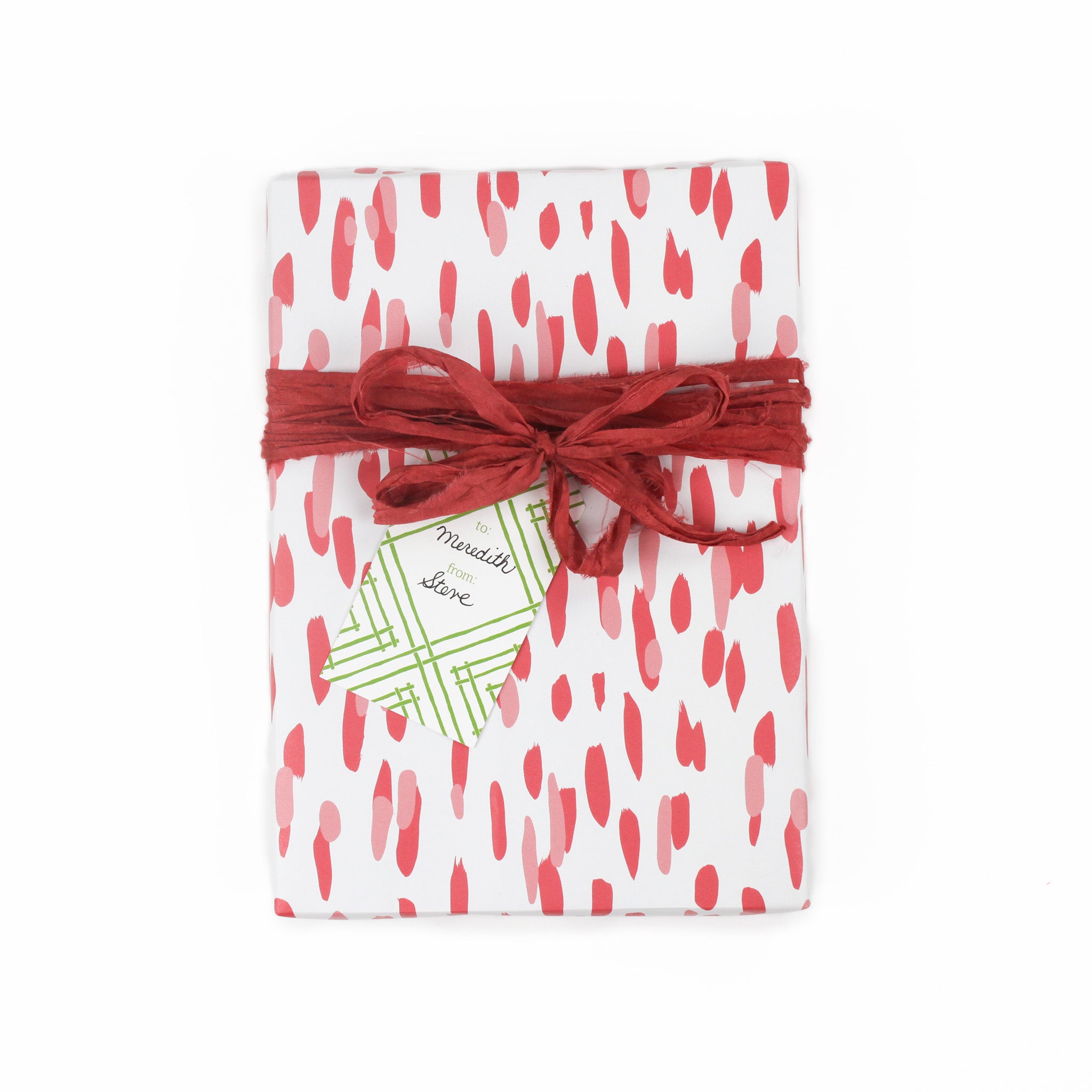 a gift tag with a geometric lattice pattern in green, added to a wrapped present