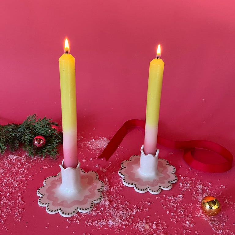 Light Green/White/Pink Color-Block Taper Candles in scalloped white candle holders with white background