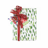 a Monserrat red gift tag with attached to a wrapped present