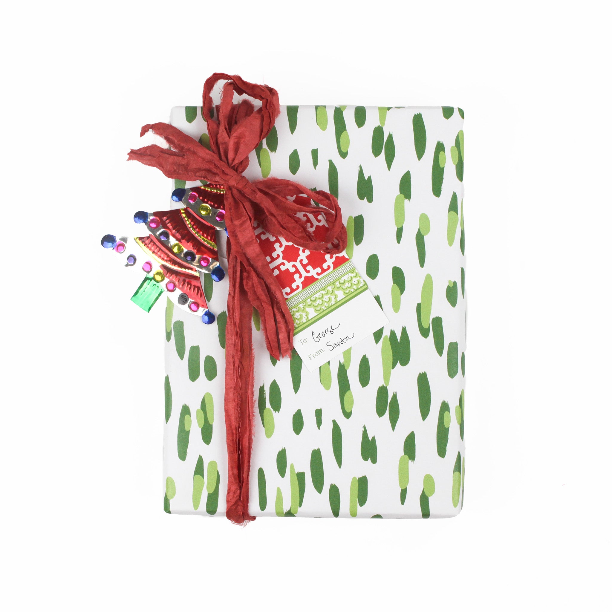 a Monserrat red gift tag with attached to a wrapped present