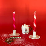 2 Red Pink Taper Candles in a holder with red background