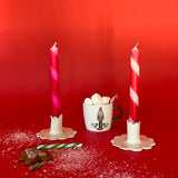 2 Red Pink Taper Candles in a holder with red background
