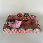 green rattan serving tray styled with champagne glasses