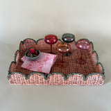 green rattan serving tray styled with champagne glasses