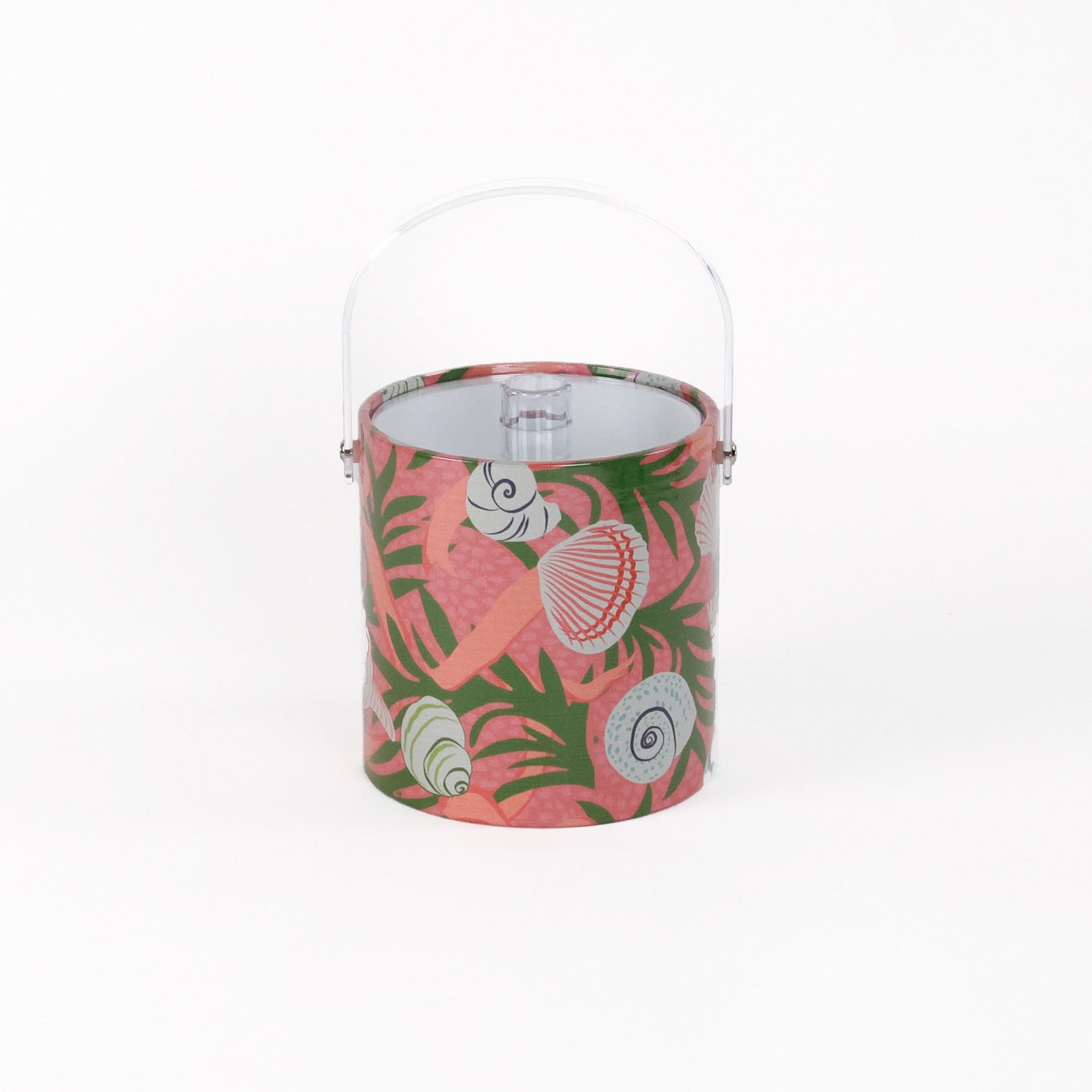 Shell Seekers is a pink acrylic ice bucket from madcap cottage covered in shell and seaweed motifs featuring a clear handle and lid