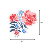 A die cut floral paper placemat featuring pink red and blue flowers displayed with 13.5" by 13.5"  dimensions on a white background.
