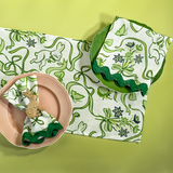 a green and white cloth table runner and napkin in a  bunnies and bow print fabric.