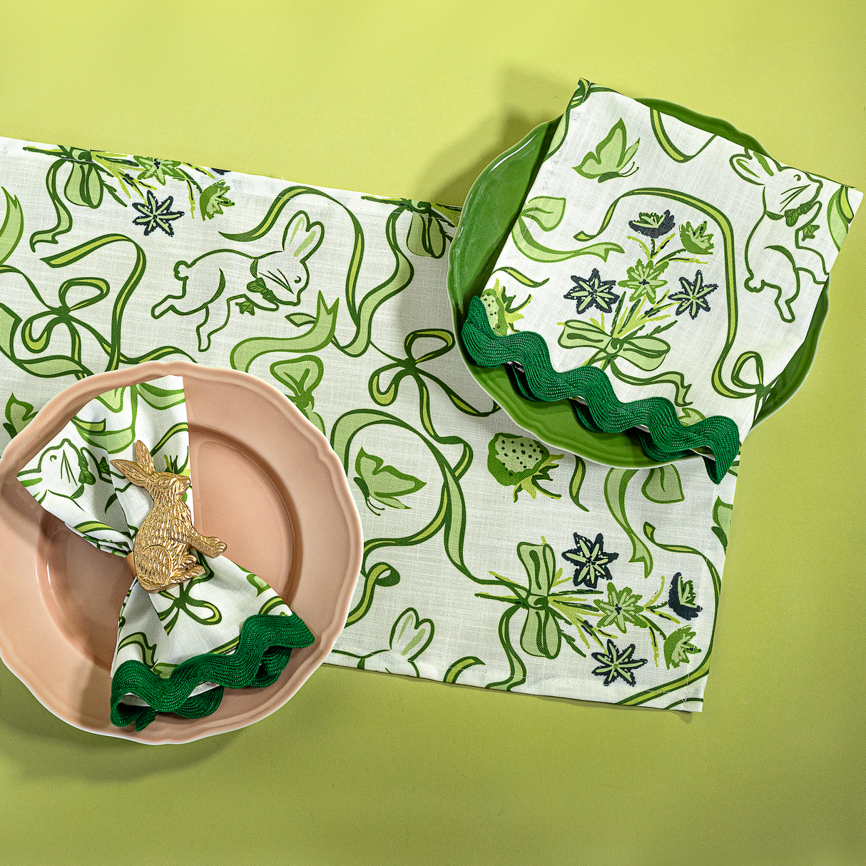 a green and white  table runner and napkin in a  bunny and bow print fabric. 