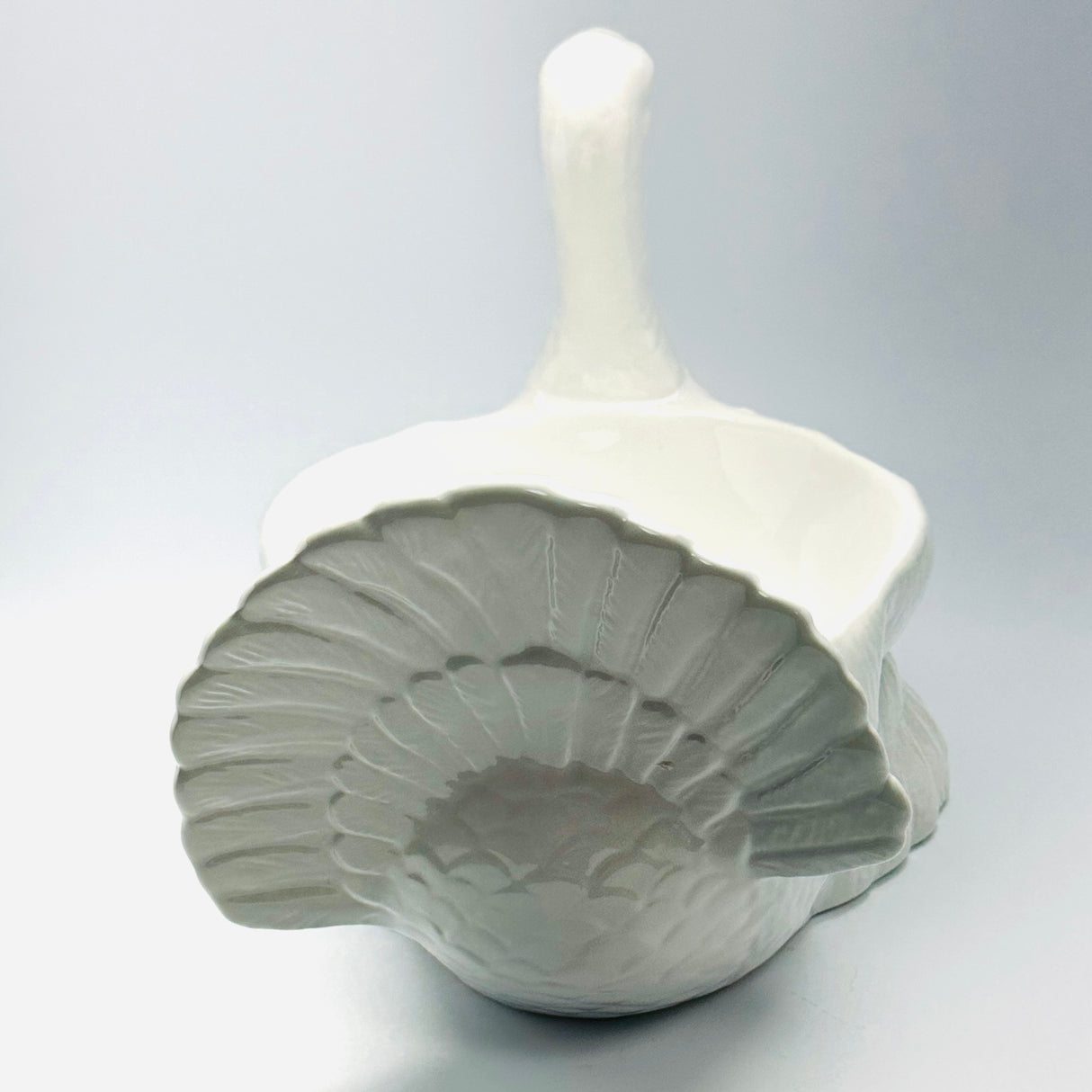 the tail of a white ceramic turkey centerpiece