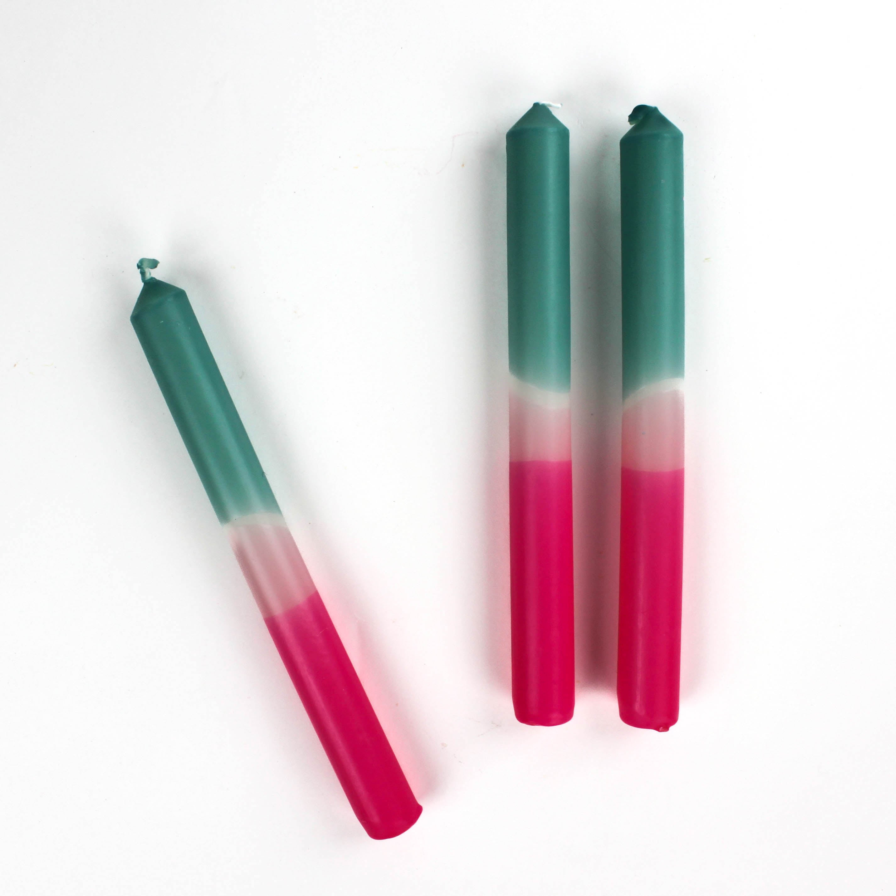3 teal and pink taper candles with white background