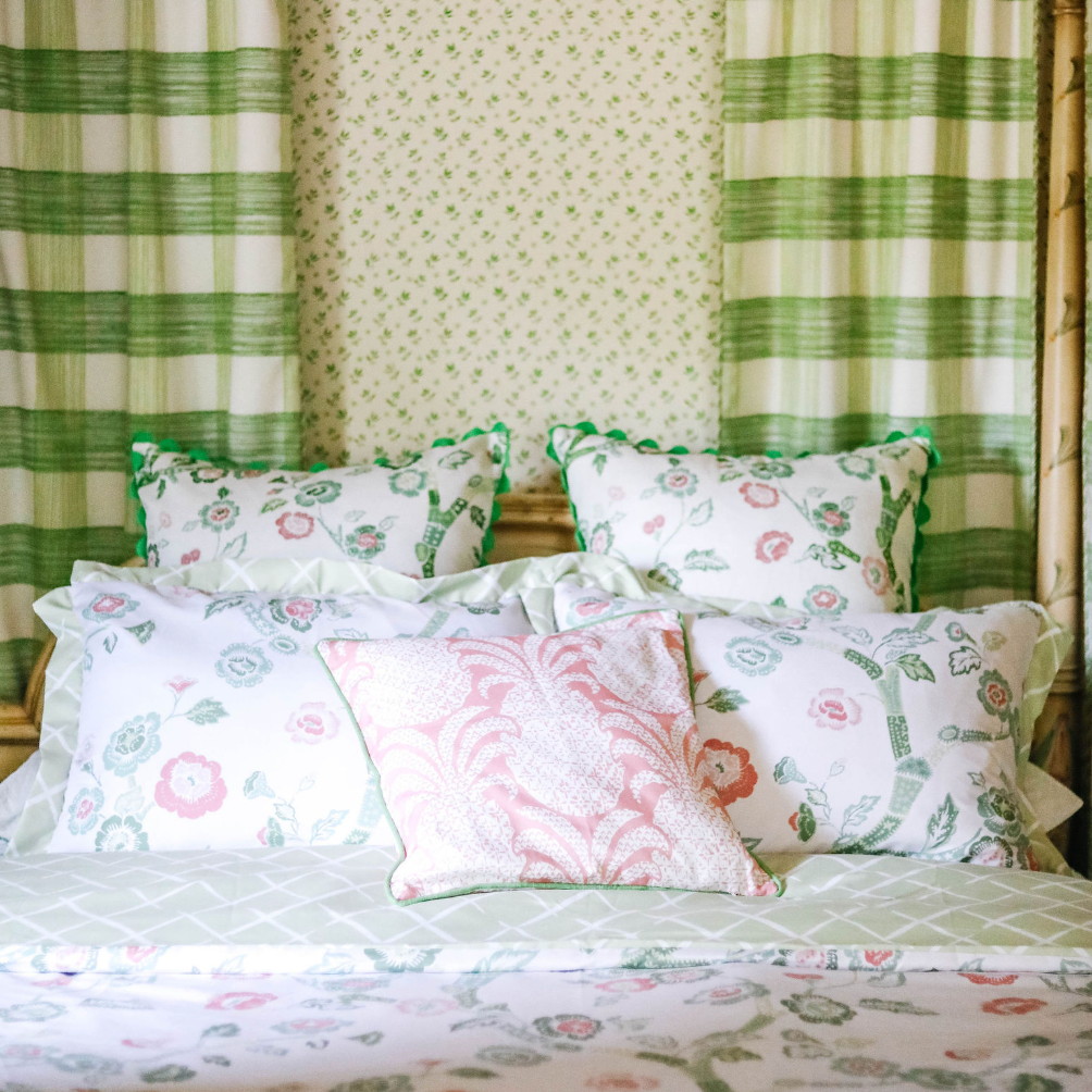 A canopy bed with pink and green chinoiserie bedding from Madcap Cottage