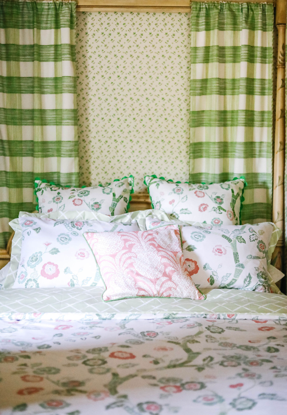 A canopy bed with pink and green chinoiserie bedding from Madcap Cottage