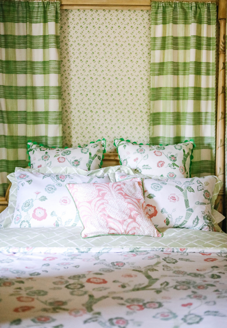 A canopy bed with pink and green chinoiserie bedding from Madcap Cottage