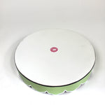 The plain white reverse side of Temple Garden, a tole metal tray with scalloped edges in green with a pink and green chinoiserie peony blossom pattern