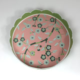 An aerial view of Temple Garden, a tole metal tray with scalloped edges in green with a pink and green chinoiserie peony blossom pattern