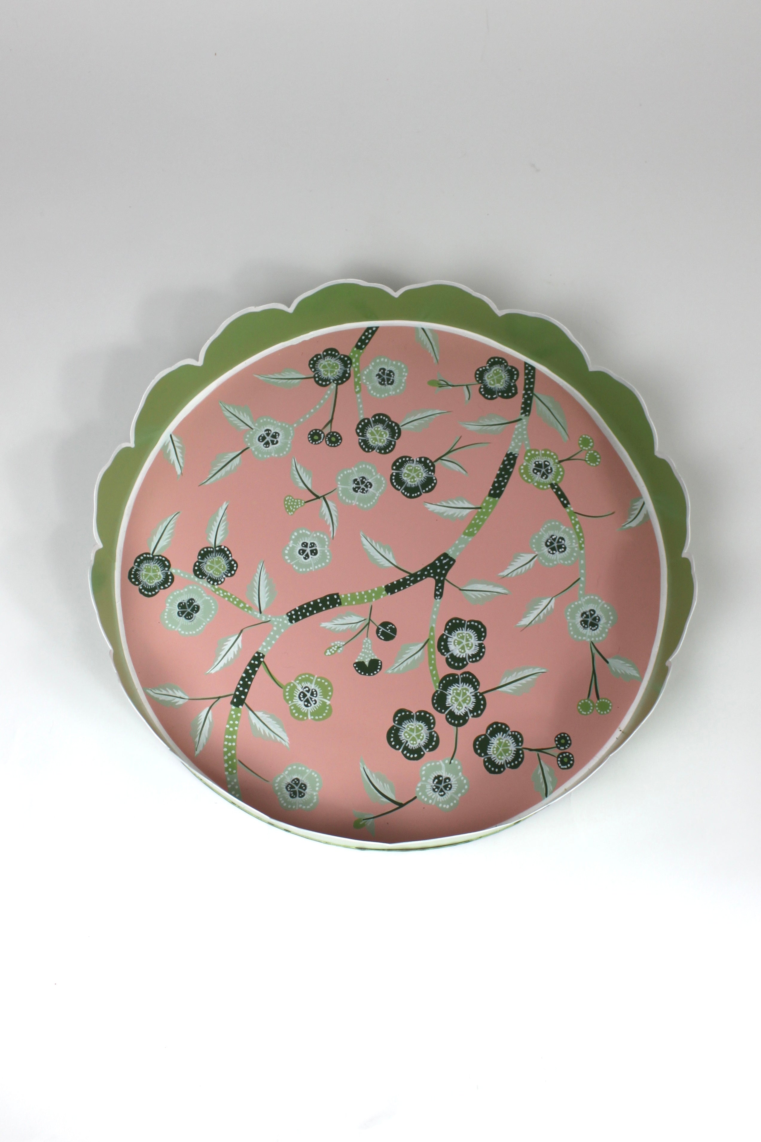 An aerial view of Temple Garden, a tole metal tray with scalloped edges in green with a pink and green chinoiserie peony blossom pattern
