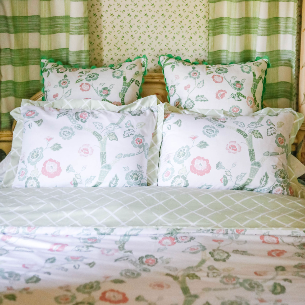A canopy bed with pink and green chinoiserie bedding from Madcap Cottage